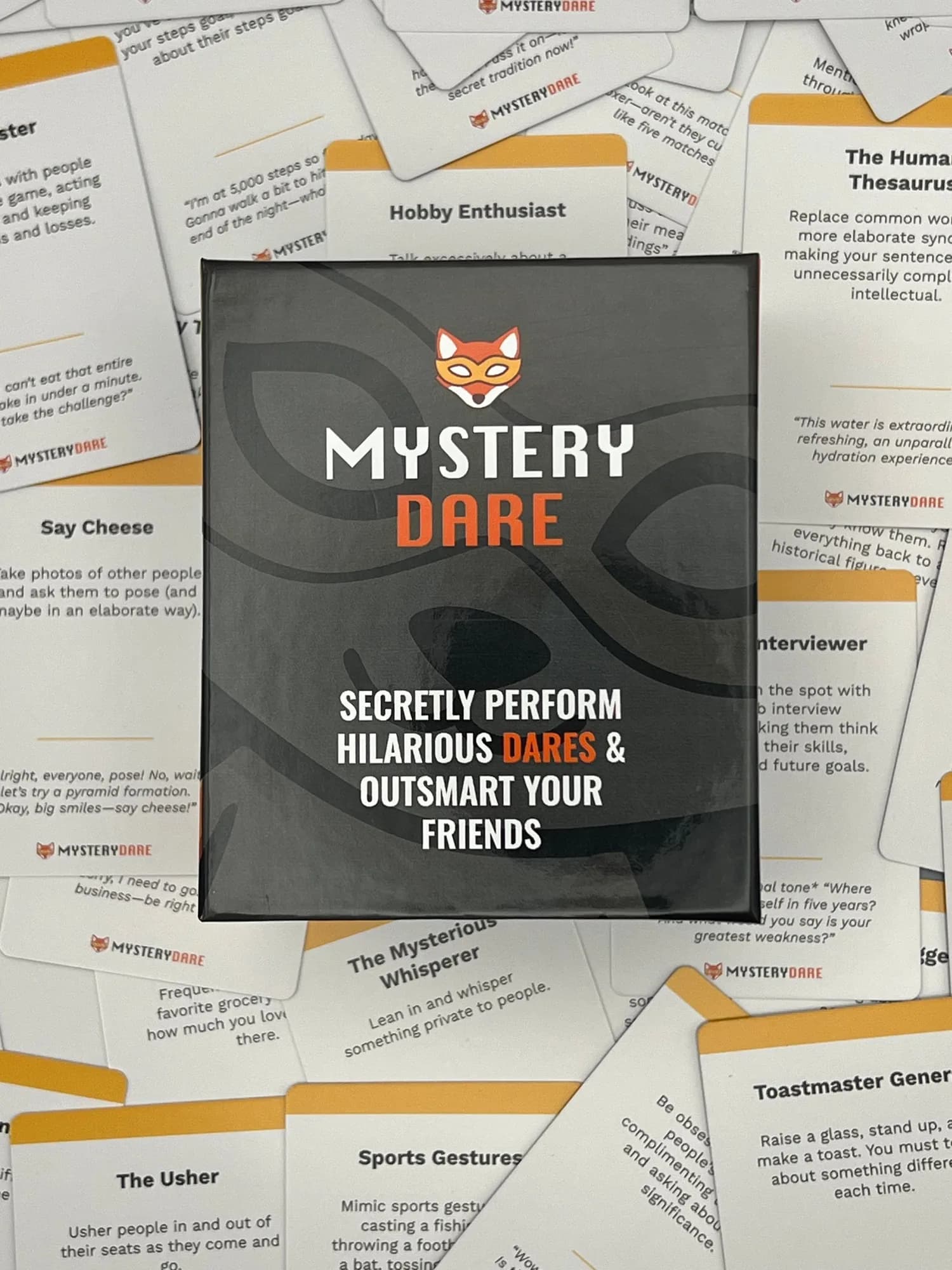 The Mystery Dare box resting on a pile of scattered dare cards